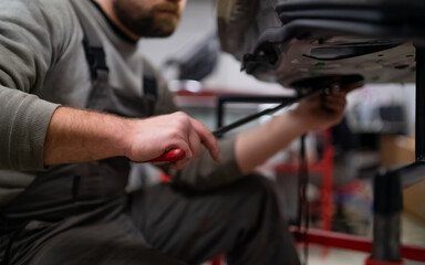 Bearded man's car repair service worker, hands photo in work repair process with a car door