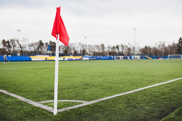 Corner red flag on soccer field - stadium competition - obrazy, fototapety, plakaty