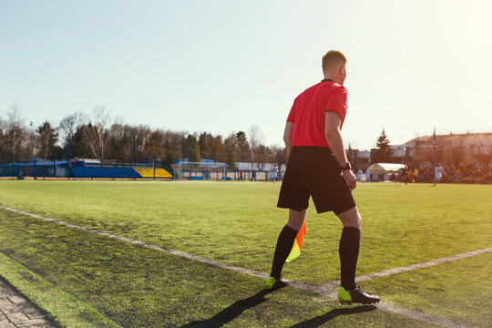 The line referee at a football match is closely following the game - the linesman