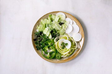 Green raw vegetables and herbs for salad
