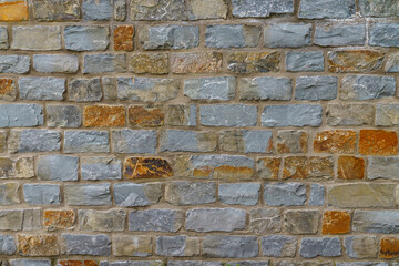 A fragment of a stone wall made of hewn stone.