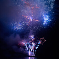 Blue holiday fireworks on night sky