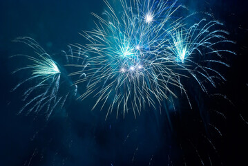 Blue holiday fireworks on night sky