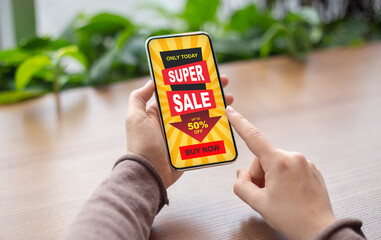 Female finger clicking on super sale offer on smartphone screen