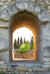 Stone window in ancient wall