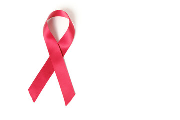 Red ribbon on white background is symbol of disease AIDS and drug abuse.