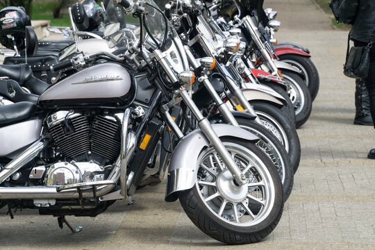 WARSAW, POLAND, APRIL 25, 2021: Classic motorcycles parked on the motorcycles parking lot. Honda Shadow in foreground. Closeup of motorcycles front wheel, tank and engine.
