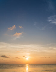 Obraz premium Sunset sky vertical over sea in the evening with colorful orange sunlight 