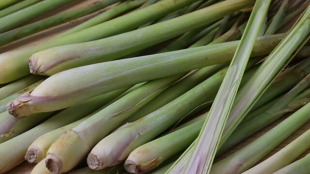 Fresh raw organic whole and sliced lemongrass stems at the market close up 