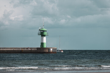 Fototapeta na wymiar at a lighthouse of travemuende ships pass by b a nice weather