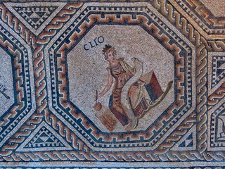 Clio - one of 9 muses portrayed in medalion with geometric ornamented borders. The Roman floor mosaic is freely accessible for everybody outdoors in Vitchen, Luxembourg