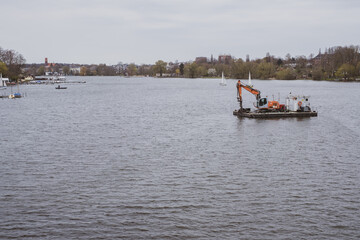 dredger is on a raft in the middle of a river