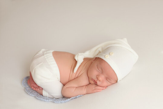 portrait of newborn baby with a white knitted. Healthy concept