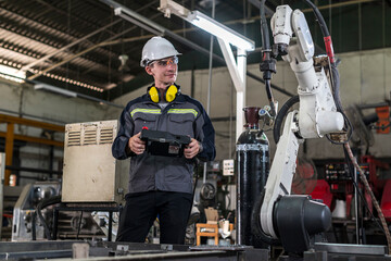 Robotics control engineers solve problems and setting programming of control panel for industrial...