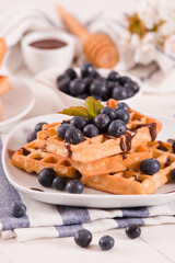 Waffles with blueberries and chocolate cream.

