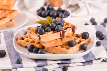 Waffles with blueberries and chocolate cream.
