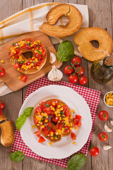 Friselle with tomatoes and mais. 