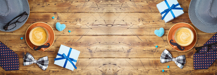 Happy Fathers day concept with coffee cup, mustache, hat, necktie and gift box on wooden background