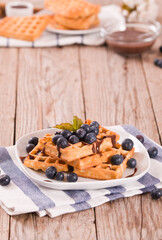 Fototapeta premium Waffles with blueberries and chocolate cream.