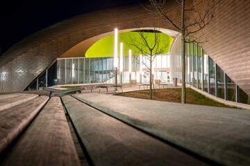 Calgary Alberta Canada, April 22 2021: Modern architecture and empty park benches at night at the...