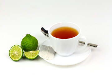 Bergamot tea or Earl Grey tea in white cup and fresh bergamot fruit with sliced isolated on white background.