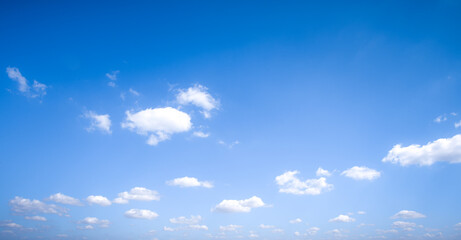 Fototapeta premium Picture of the blue sky on a bright day with white clouds. This image is used as a background image or for copy space.