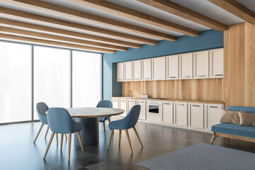 Stylish kitchen room interior with dining table and chairs. Panoramic window, tile ceramic floor, wooden wall.