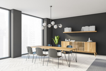Interior design of luxury living room with stylish commode table and furniture. Dark grey wall with book shelf. Modern home decor. Panoramic window.