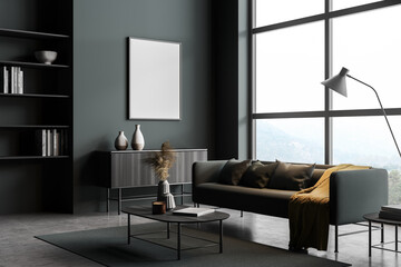 Dark living room interior with sofa and drawer with mockup poster near window