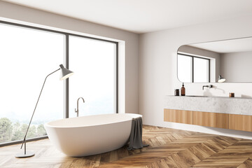 Fototapeta na wymiar Bathroom interior with bathtub and sink with window on countryside