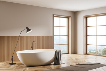 Fototapeta na wymiar Bathroom interior with bathtub and foot towel with lamp on wooden floor