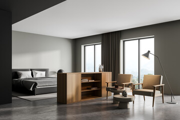 Light bedroom interior with armchairs and bed on concrete floor with windows