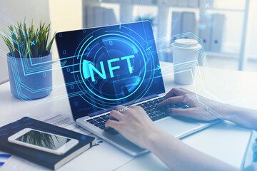 Businesswoman hands on laptop, digital hud with nft symbol and coding
