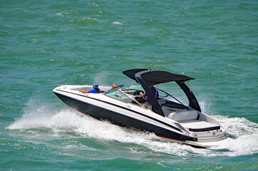 High-end black and white motorboat cruising on the Florida Intra-Coastal Waterway  near Miami...