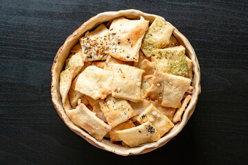 Homemade chickpea hummus and herbal healthy baked wheat vegan vegetarian cracker appetizer food...