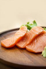 salmon sashimi in chopsticks, Raw fresh salmon sliced with wasabi and sauce. Japanese food style
