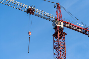 Naklejka premium tower crane and protective screens around the building under construction technology