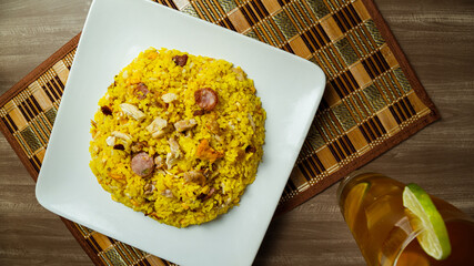 Paisa rice typical Colombian food with a water of panela with lemon