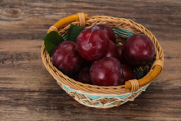 Plum heap in the wooden basket