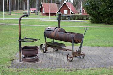 Rusty barbecue oven in an outdoor grilling area. Beautifully designed old grill equipment in outdoor kitchen.