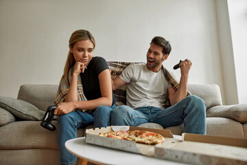 Picture of a young couple on self isolation playing on console