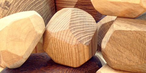 Fototapeta na wymiar Wooden irregular tumi ishi toy blocks of different wood types.