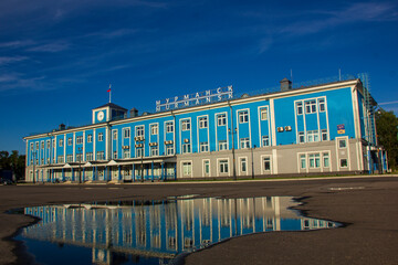 Fototapeta premium Marine Terminal in Murmansk and its reflection in a rain puddle, Russia, August 2020