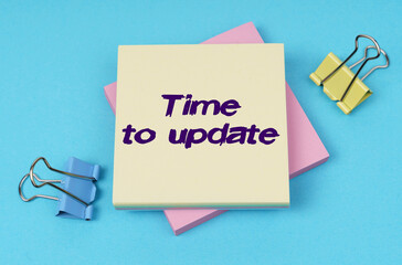 On the table are paper clips, note paper with text - Time to update