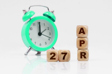 On a white background there is an alarm clock and a calendar with the inscription - April 27