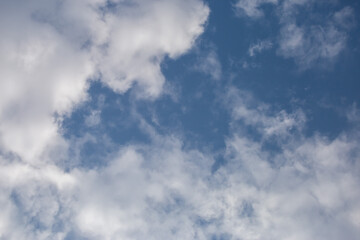 Soft white clouds in the close-up sky look dense, beautiful for background design, copy space available. Blue background