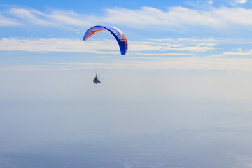 Paragliders in blue sky. Concept of active lifestyle and extreme sport adventure