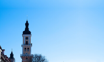 Obraz premium An ancient clock tower with a spire. Clock. Middle Ages. Old city.