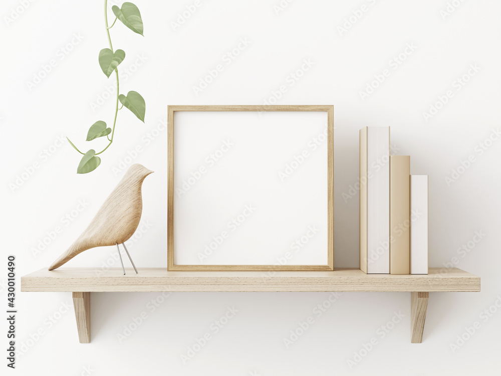 Leinwandbilder small square wooden frame mockup in scandi style interior with trailing green plant, bird, pile of b
