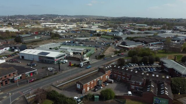 Aerial drone panning across rural village houses and supermarket, Essex England